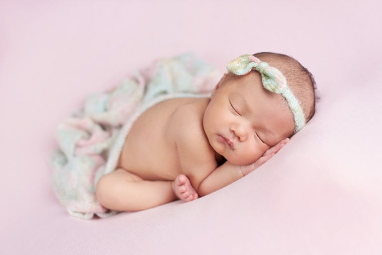 Sleeping beauty baby photo professional newborn photography with elegant pink backdrop for girl in Philadelphia, Pennsylvania